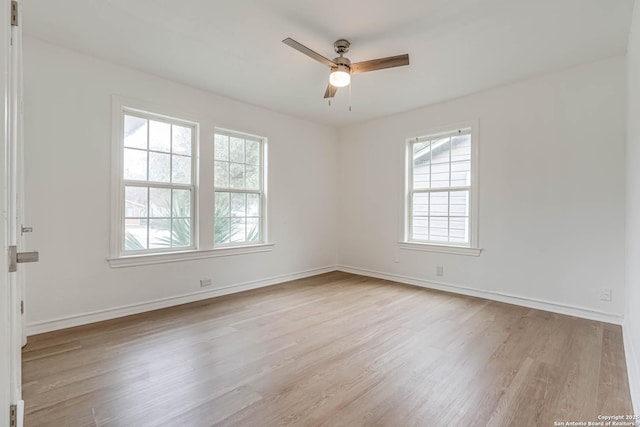 empty room with light hardwood / wood-style flooring and ceiling fan