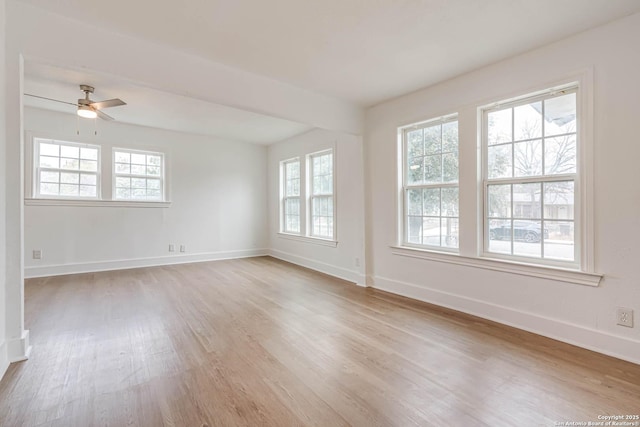 empty room featuring ceiling fan and light hardwood / wood-style flooring