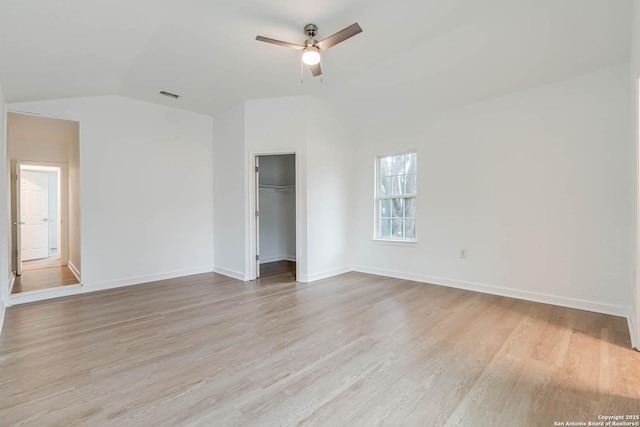 unfurnished bedroom with vaulted ceiling, light hardwood / wood-style floors, a closet, and ceiling fan