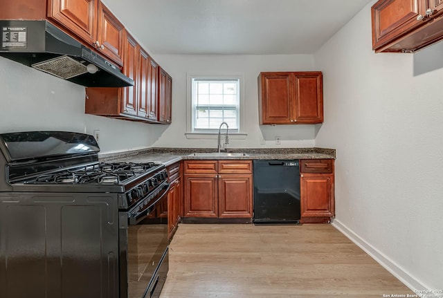 kitchen featuring sink, black appliances, and light hardwood / wood-style floors