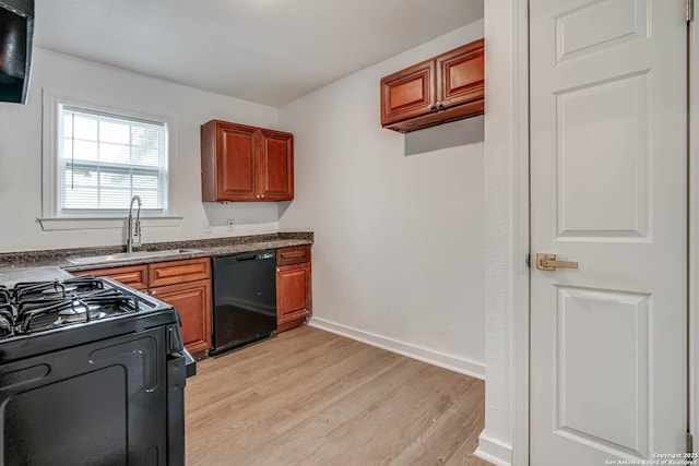 kitchen featuring sink, black appliances, and light hardwood / wood-style floors