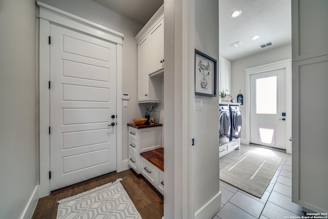 mudroom featuring wood-type flooring and washer and clothes dryer