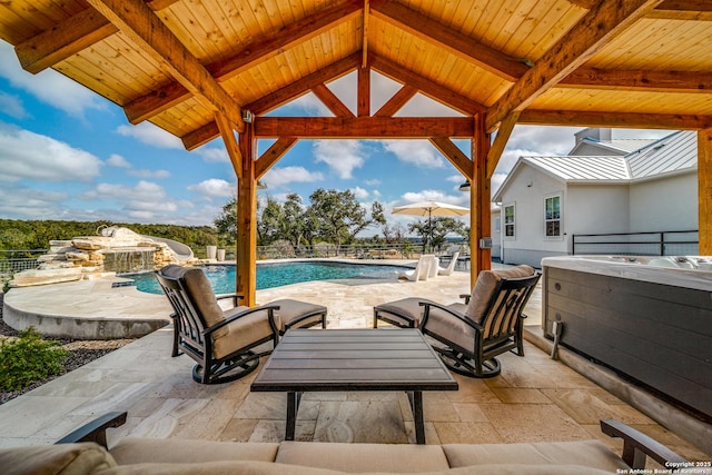 view of patio / terrace with a pool with hot tub and a gazebo