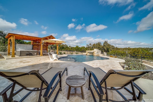 view of swimming pool with a hot tub, pool water feature, and a patio area