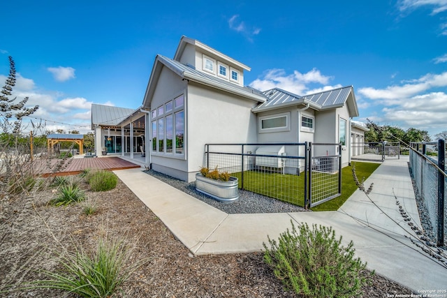 view of side of property featuring a yard and a deck