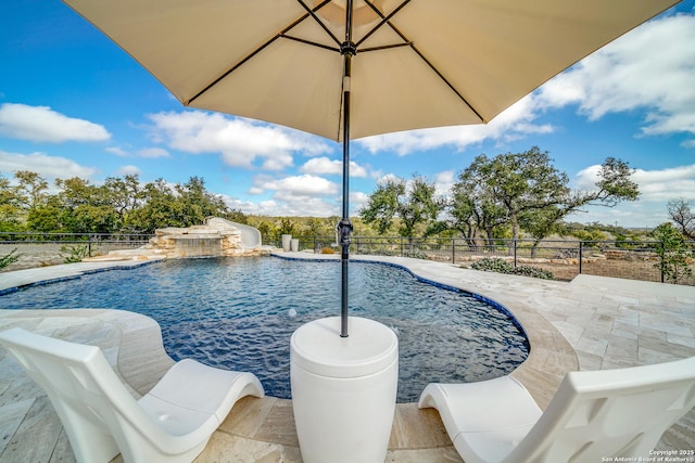 view of pool with pool water feature and a patio