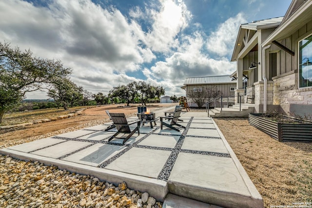 view of patio / terrace featuring an outdoor fire pit