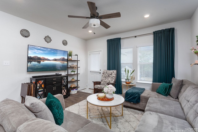 living room with light hardwood / wood-style floors and ceiling fan