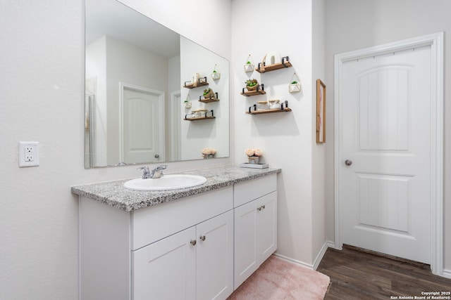 bathroom with vanity and wood-type flooring