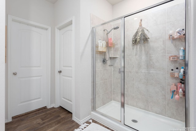 bathroom featuring hardwood / wood-style flooring and walk in shower