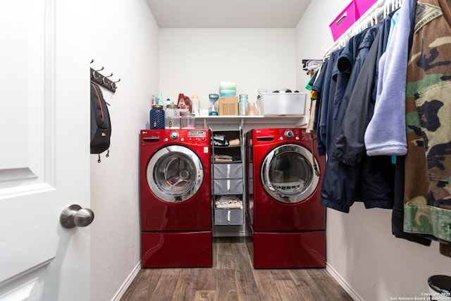 clothes washing area with washing machine and dryer and dark hardwood / wood-style flooring