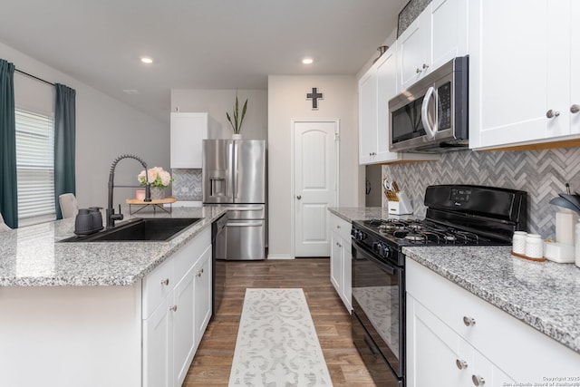 kitchen featuring white cabinetry, sink, dark hardwood / wood-style flooring, light stone counters, and black appliances