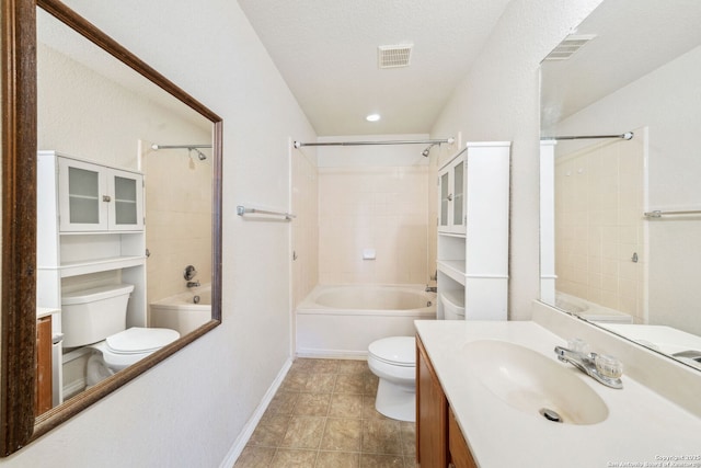 full bathroom with vanity, tiled shower / bath combo, a textured ceiling, and toilet