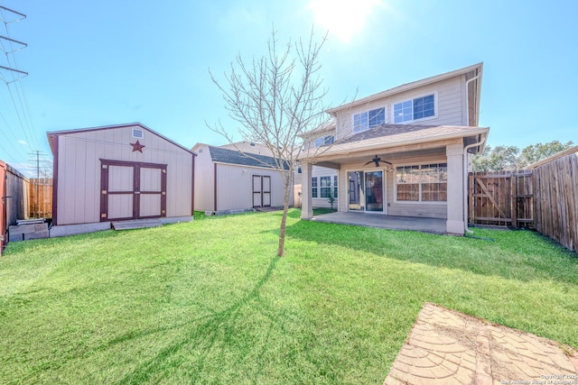 rear view of property featuring a patio, a yard, ceiling fan, and a shed