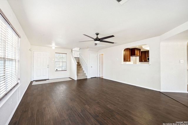 unfurnished living room featuring dark hardwood / wood-style floors and ceiling fan