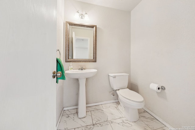 bathroom featuring toilet and sink