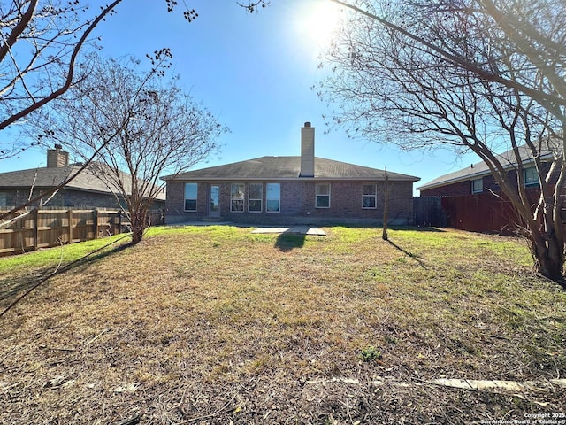 back of property with a lawn