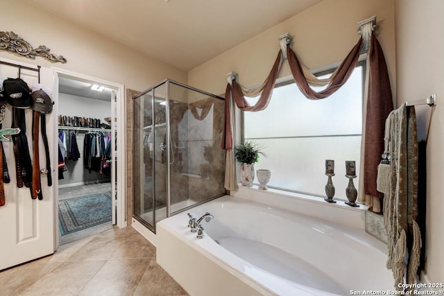 bathroom featuring tile patterned floors and independent shower and bath