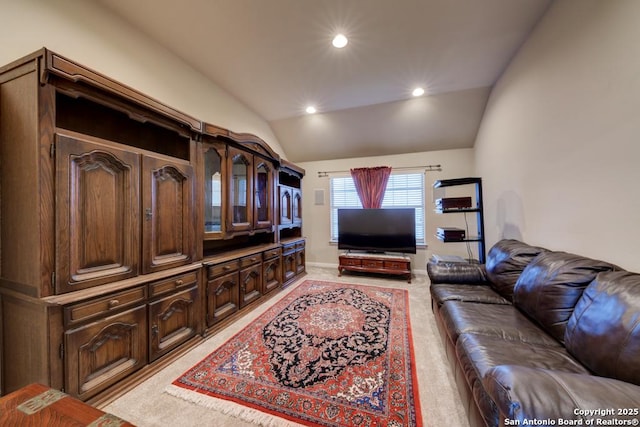 living room featuring light colored carpet and lofted ceiling