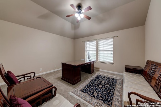 carpeted office space with ceiling fan and vaulted ceiling