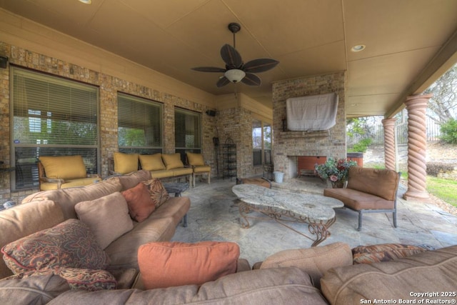 view of patio featuring an outdoor living space with a fireplace and ceiling fan