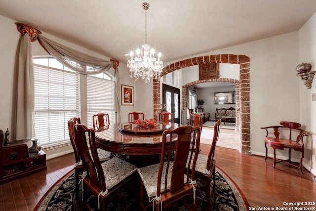 dining area featuring an inviting chandelier and dark hardwood / wood-style floors