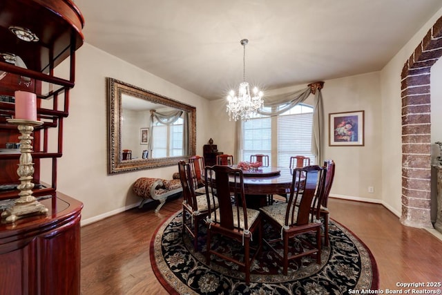 dining space featuring a chandelier and dark hardwood / wood-style flooring