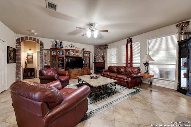 tiled living room featuring ceiling fan