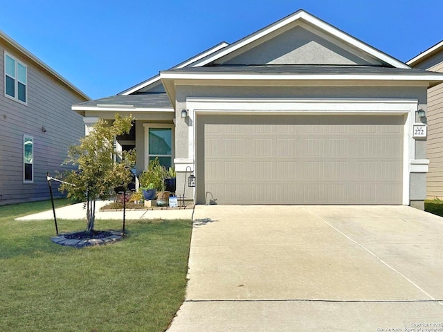 view of front of property with a garage and a front lawn