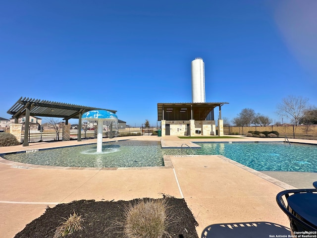 view of swimming pool featuring pool water feature, a patio area, and a pergola