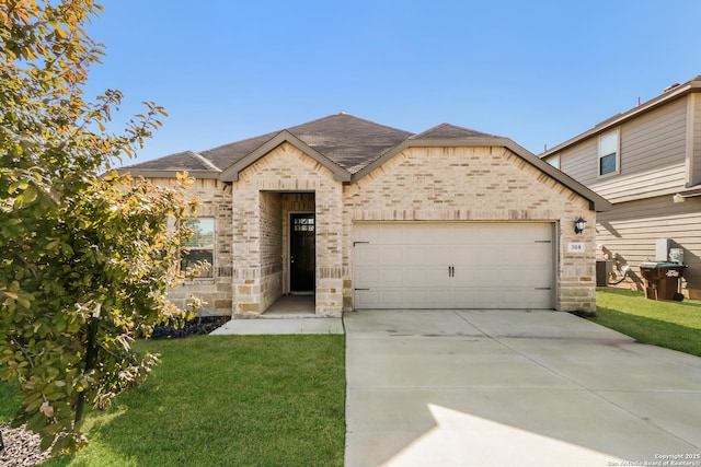 view of front of property with a garage and a front lawn