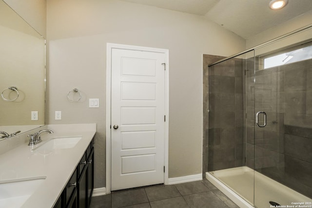 bathroom with tile patterned flooring, vanity, lofted ceiling, and an enclosed shower