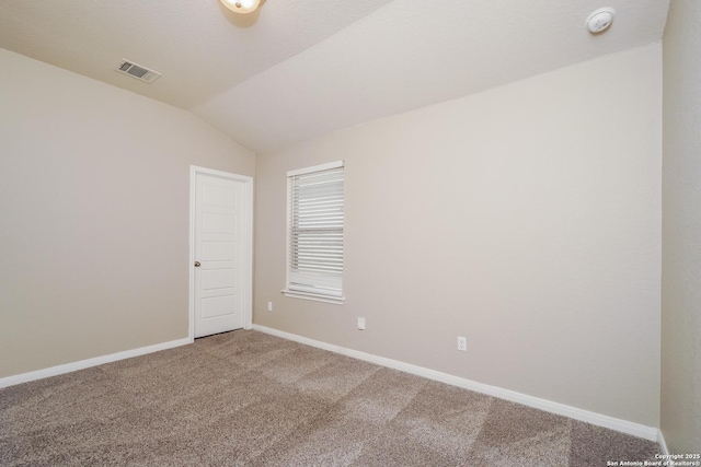 empty room with lofted ceiling and carpet