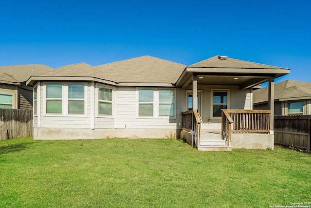 rear view of house with a yard