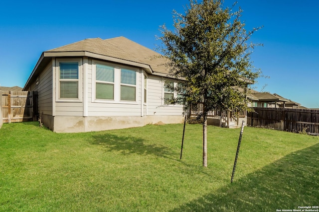 view of side of home with a lawn