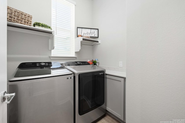 washroom with plenty of natural light and independent washer and dryer