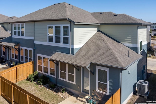 rear view of house with central AC unit