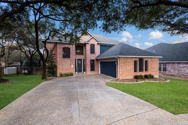 view of front property with a garage and a front yard