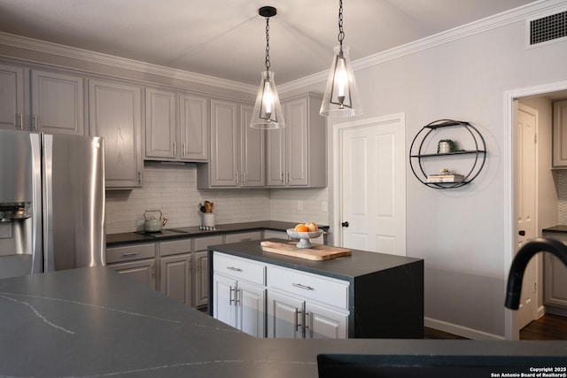 kitchen featuring tasteful backsplash, ornamental molding, gray cabinets, and stainless steel fridge with ice dispenser