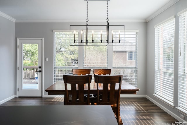 dining area featuring an inviting chandelier, ornamental molding, and dark wood-type flooring