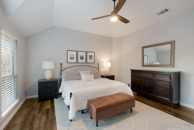 bedroom with dark wood-type flooring, ceiling fan, and vaulted ceiling