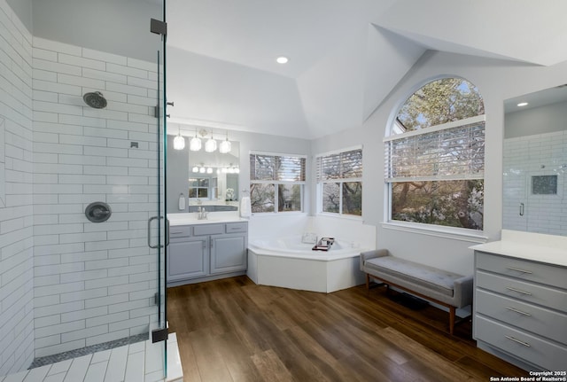 bathroom featuring lofted ceiling, vanity, separate shower and tub, and wood-type flooring