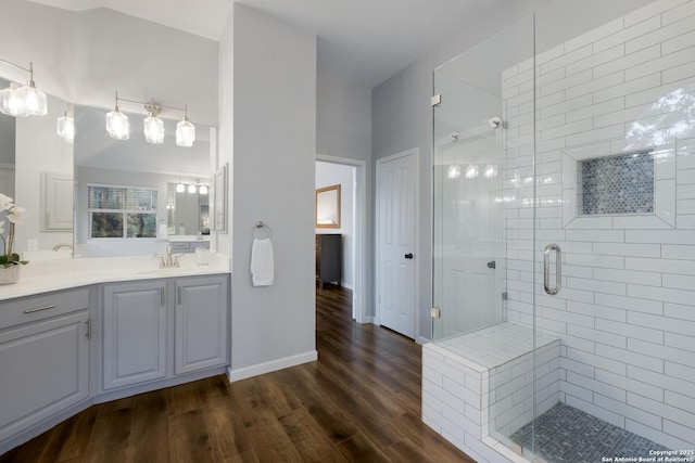 bathroom featuring a shower with door, wood-type flooring, and vanity