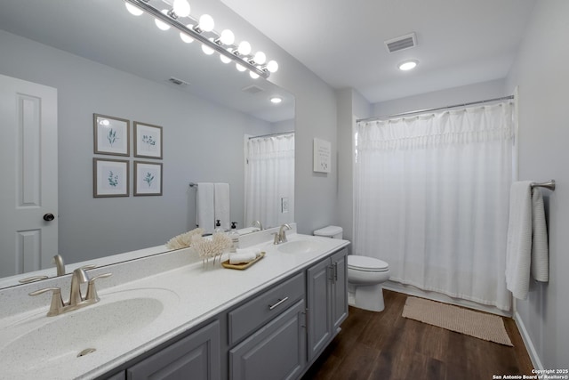 bathroom featuring hardwood / wood-style flooring, vanity, and toilet