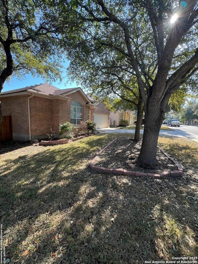 exterior space featuring a garage and a front yard