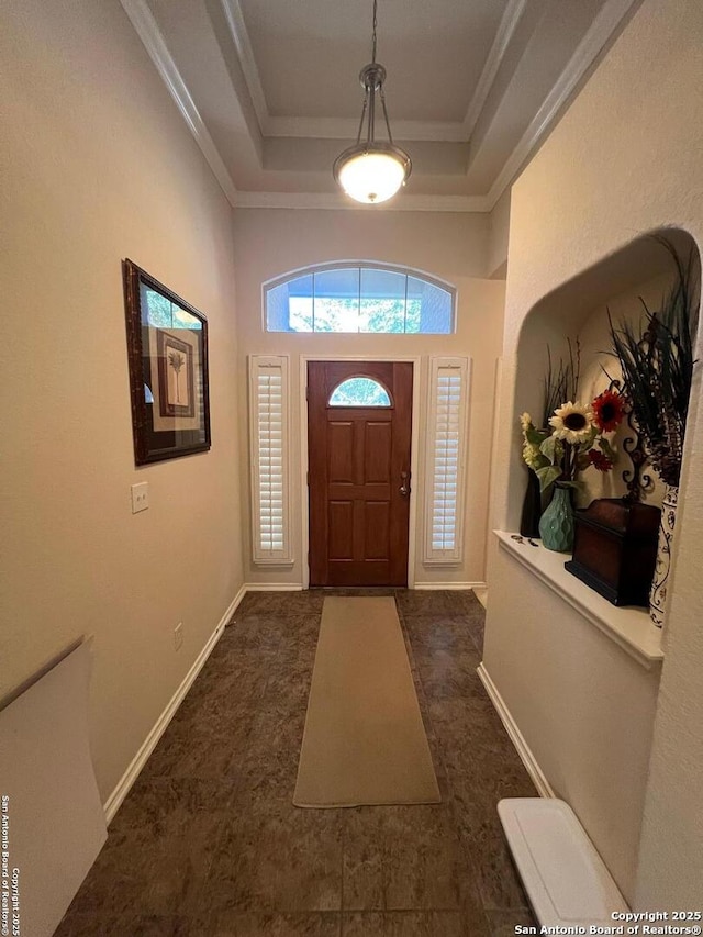 entryway featuring crown molding and a tray ceiling