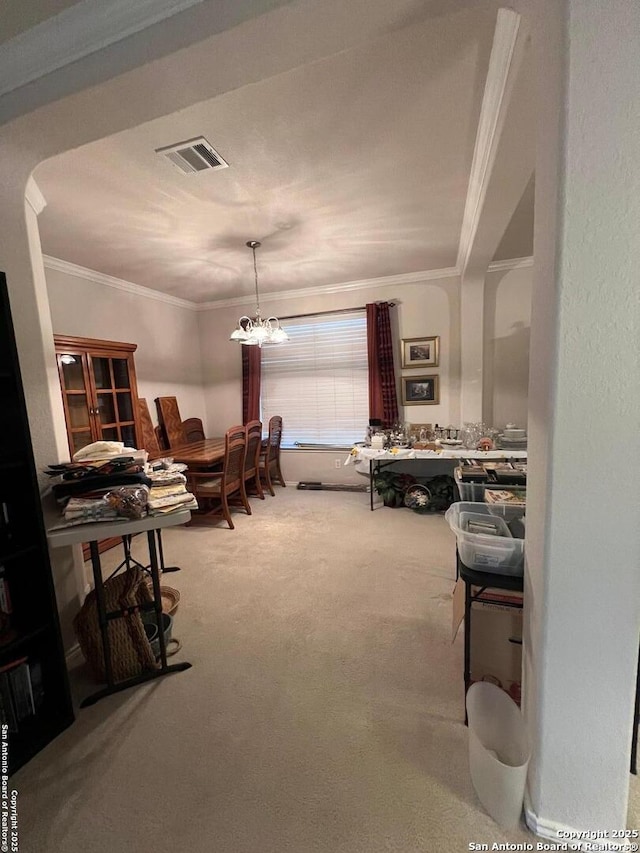 interior space featuring ornamental molding, carpet flooring, and a chandelier