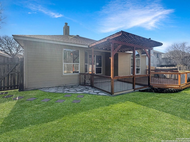 rear view of property with a yard