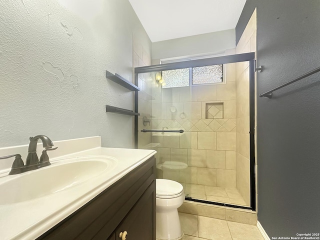 bathroom with tile patterned floors, vanity, toilet, and a shower with shower door