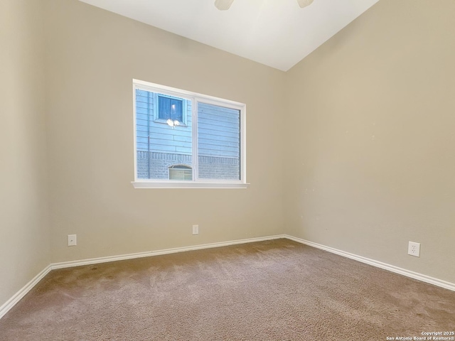 carpeted empty room with vaulted ceiling and ceiling fan